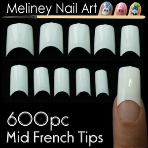May include: 600 white plastic nail tips for creating a mid-french manicure. The tips are arranged in rows on a black surface. One tip is shown on a finger.