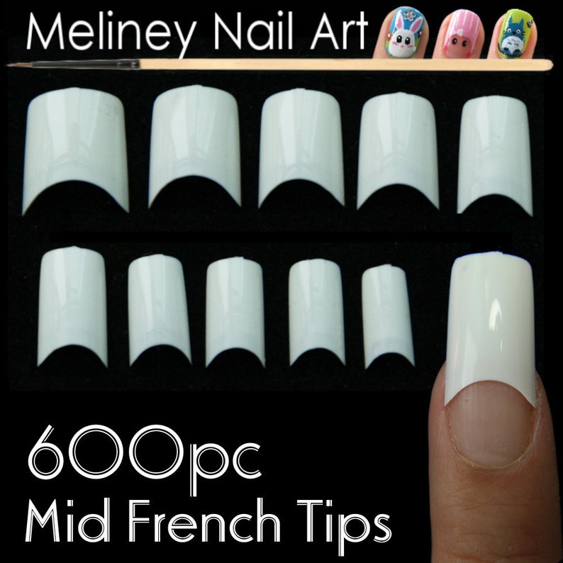 May include: 600 white plastic nail tips for creating a mid-french manicure. The tips are arranged in rows on a black surface. One tip is shown on a finger.