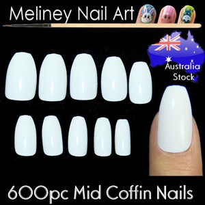 May include: 600 white mid coffin shaped false nails. The nails are arranged in two rows of six. The nails are on a black background. The text "600pc Mid Coffin Nails" is at the bottom of the image.