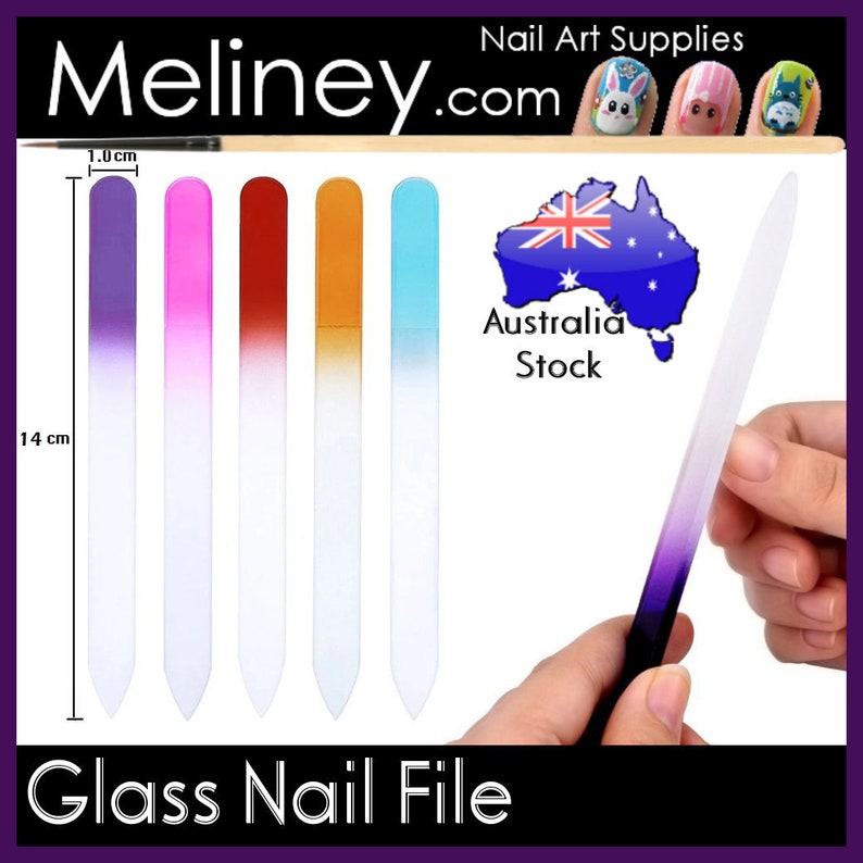 May include: Set of five glass nail files with a gradient colour design. The files are 14 cm long and 1 cm wide. The colours are purple, pink, red, orange, and blue. The files are made of glass and are designed for filing and shaping nails. The image also shows a single glass nail file being held by a hand. The image includes the text "Meliney.com" and "Glass Nail File".