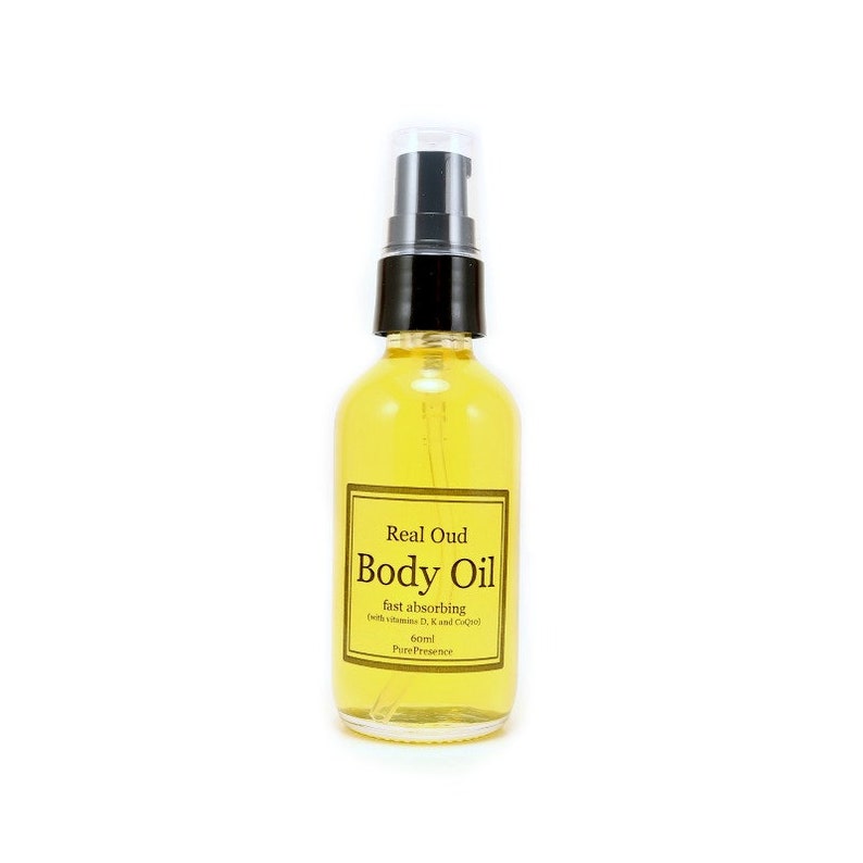 May include: A clear glass bottle with a black pump top filled with yellow body oil. The label reads "Real Oud Body Oil fast absorbing (with vitamins D, K and CoQ10) 60ml PurePresence"