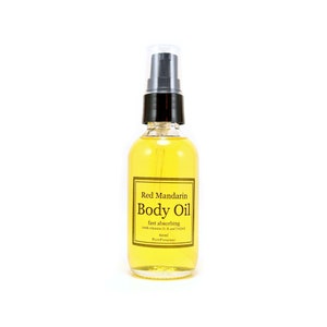 May include: A clear glass bottle of Red Mandarin Body Oil with a black pump top. The label is gold with black text that reads "Red Mandarin Body Oil fast absorbing with vitamin D, K and CoQ10 60ml Pure Presence".