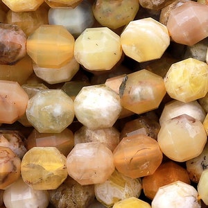 May include: A strand of faceted opal beads in shades of yellow, green, and white. The beads are approximately 8mm in size and have a natural, irregular shape.