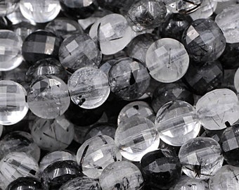 May include: A strand of faceted round black tourmaline and clear quartz beads. The beads are approximately 6mm in diameter and have a smooth, polished finish.