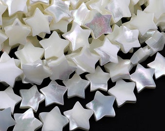 May include: A strand of white star-shaped beads made from mother of pearl. The beads have a slightly iridescent sheen.