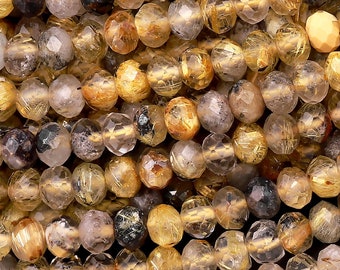 May include: Close-up of a pile of faceted, round beads in shades of gold, brown, and clear. The beads are strung together, creating a textured surface. The beads have a sparkling, polished appearance, suggesting they are made of a gemstone or crystal.