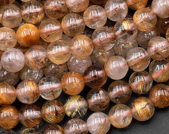May include: A strand of round, translucent beads with gold and copper inclusions. The beads are approximately 8mm in diameter and have a natural, polished finish.