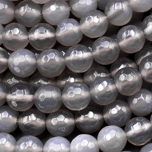 May include: A strand of gray faceted agate beads. The beads are round and have a smooth, polished finish.