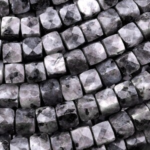 May include: A strand of black and grey faceted gemstone beads. The beads are square shaped and have a smooth, polished finish.