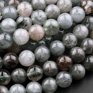 May include: A strand of round, translucent green and gray gemstone beads. The beads have a cloudy, marbled appearance with hints of brown and green.