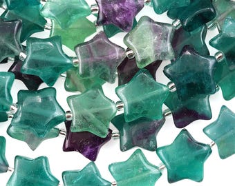 May include: Strands of star-shaped beads in shades of green, teal, and purple. The beads are strung together with silver-colored connectors. The translucent beads have a polished finish and are arranged closely together.