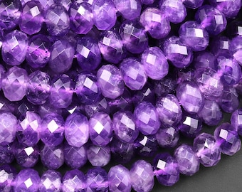 May include: A strand of faceted amethyst beads. The beads are a deep purple color and have a smooth, polished finish.