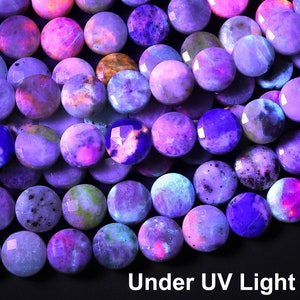 May include: A close-up of a strand of round, purple and pink gemstone beads. The beads are arranged in a line and are illuminated by a UV light, causing them to glow brightly. The text "Under UV Light" is visible at the bottom of the image.