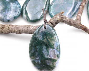 May include: A green moss agate pendant with a brown leather cord. The pendant is teardrop shaped and has a natural, organic look.