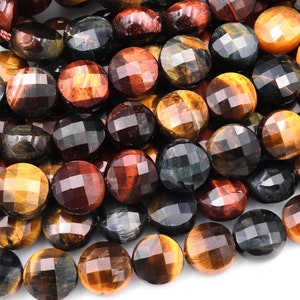May include: A strand of faceted tiger's eye beads in shades of brown, gold, red, and blue. The beads are round and have a smooth, polished finish.