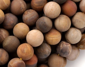 May include: A strand of brown, beige, and red agate beads. The beads are round and have a smooth, polished finish.