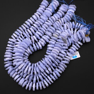 May include: A strand of blue lace agate beads, each bead is faceted and has a unique shape. The beads are strung on a thin cord and are ready to be used for jewellery making.