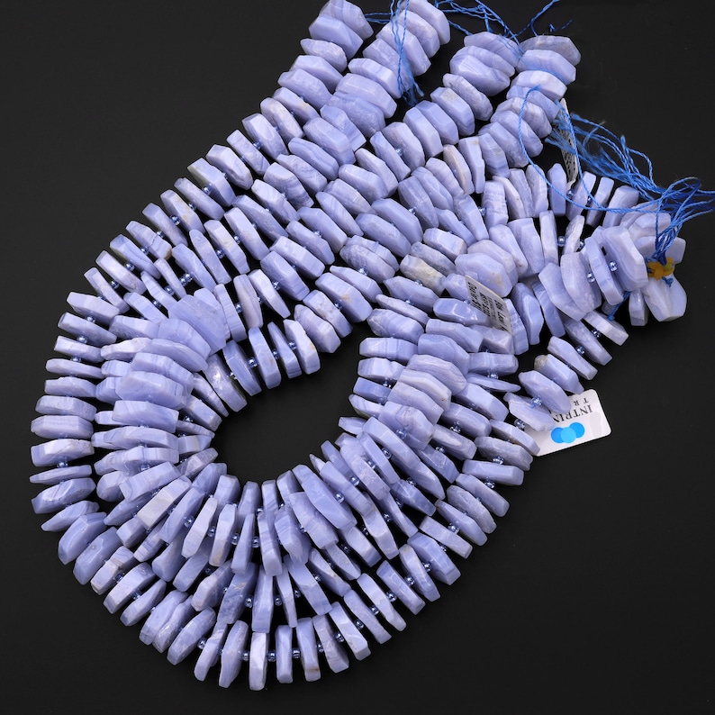 May include: A strand of blue lace agate beads, each bead is faceted and has a unique shape. The beads are strung on a thin cord and are ready to be used for jewellery making.