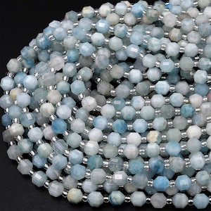 May include: A strand of light blue aquamarine gemstone beads. The beads are faceted and have a silver-toned metallic coating.