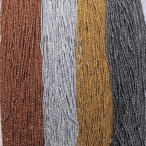 May include: Four strands of metallic beads in copper, silver, gold, and black.