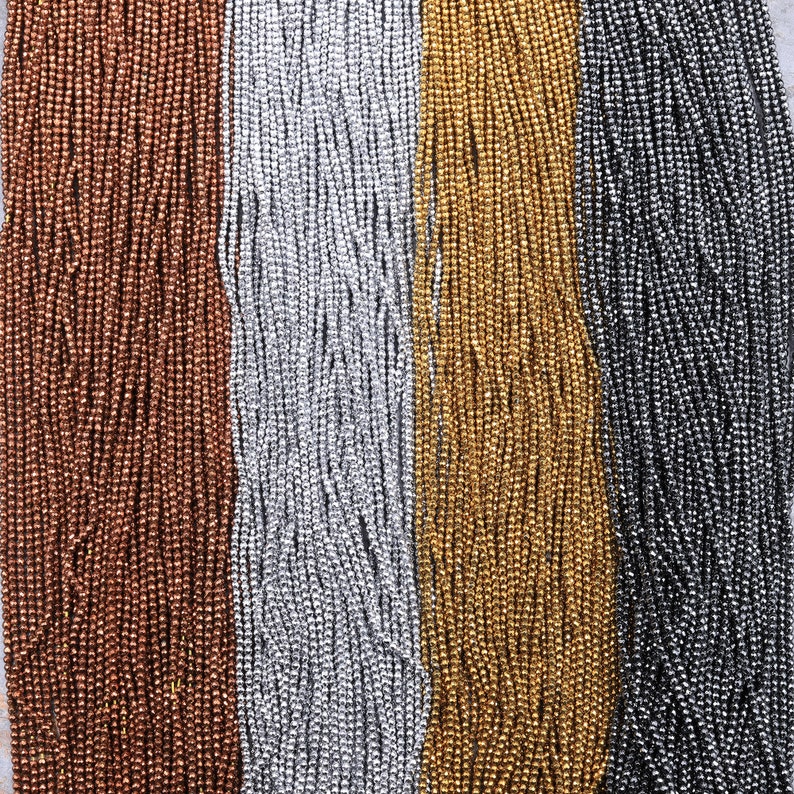 May include: Four strands of metallic beads in copper, silver, gold, and black.