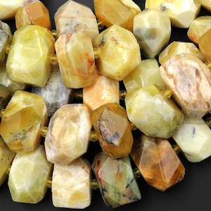 May include: A strand of yellow, green, and orange opal beads. The beads are faceted and have a natural, rough texture.