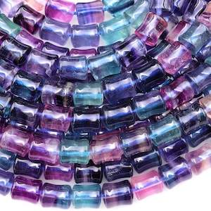 May include: A strand of multi-colored fluorite beads. The beads are faceted and have a smooth, polished finish. The colors of the beads are blue, purple, and green.