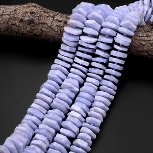 May include: A strand of light blue agate beads, each bead is faceted and has a unique shape. The beads are strung on a wire and are ready to be used for jewellery making.