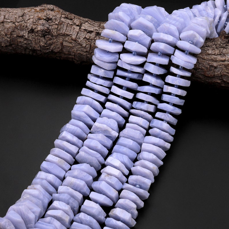 May include: A strand of light blue agate beads, each bead is faceted and has a unique shape. The beads are strung on a wire and are ready to be used for jewellery making.