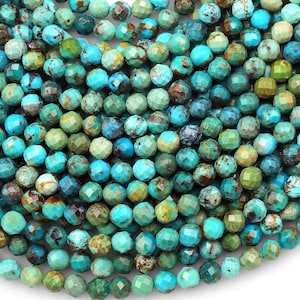 May include: A strand of turquoise gemstone beads, each bead is faceted and has a unique blue and green color variation.