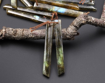 May include: Two long, thin, iridescent labradorite gemstone pendants with a brown string attached to each.