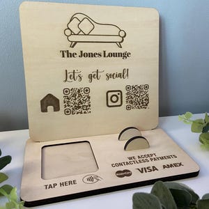 May include: Wooden business sign featuring "The Jones Lounge" and "Let's get social!" Includes QR codes, a "Tap Here" section, and accepts contactless payments with MasterCard, Visa, and Amex.