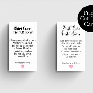 May include: Two printable cards with instructions for caring for a shirt. The cards are white with black text and a pink heart. The text on the cards reads "Shirt Care Instructions" and includes instructions for washing, drying, and ironing the shirt. The cards also include the phrase "handmade with love".