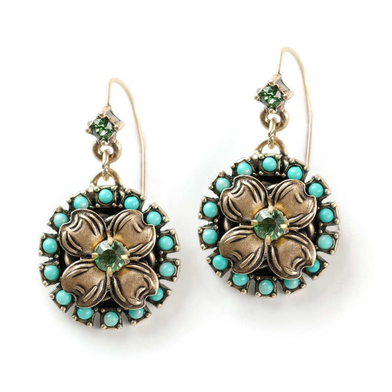 May include: A pair of gold tone earrings with a turquoise and green stone flower design.