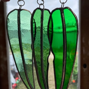 Australian Christmas decorations, stained Glass Gum leaves in green glass. Australian eucalypts.