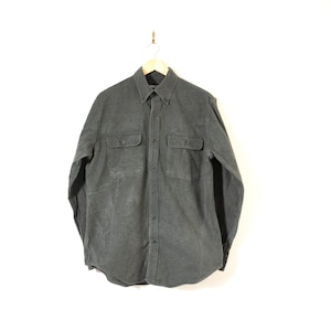 May include: A dark grey long-sleeved button-down shirt with two flap pockets on the chest.