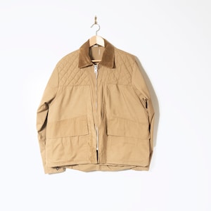 May include: A tan quilted jacket with a corduroy collar and two large pockets on the front.