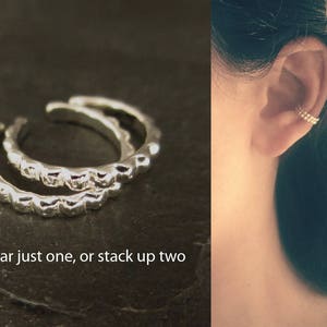 On the left is a pair of sterling silver ear cuffs. On the right a woman is shown wearing two ear cuffs on the same ear, one on top of the other, in a stack.