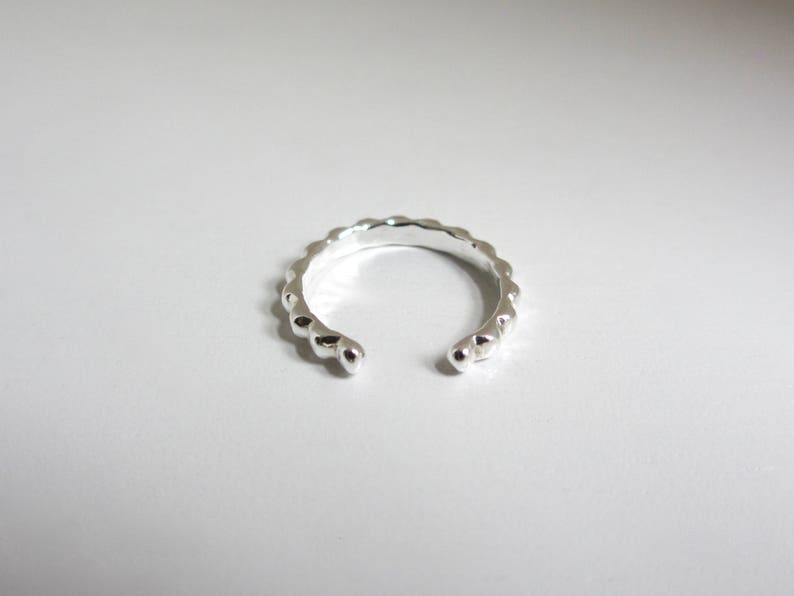 Non pierced sterling silver ear cuff has an opening that is meant to slide it on and off the ear. The ends are smooth and rounded for comfort.