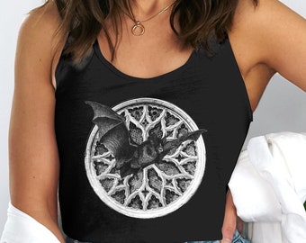 May include: Black tank top with a graphic of a bat flying through a gothic window. The window is white and the bat is black.