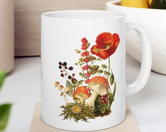May include: White ceramic mug with a colorful floral design featuring red poppies, mushrooms, and berries. The design is in a vintage style.