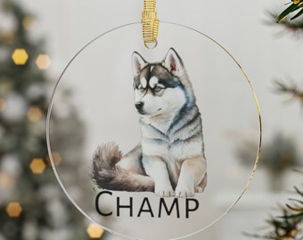 May include: Round glass Christmas ornament featuring a watercolor painting of a gray and white husky puppy sitting. The ornament has a gold ribbon and the text "CHAMP" printed below the puppy.