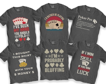 May include: Six charcoal gray short-sleeve t-shirts featuring poker-themed graphics and text. Designs include playing cards, card suits, and phrases like I've Seen My Hand You Should Fold, I'd Rather Be Playing, Poker Pro, and I'm Probably Bluffing.
