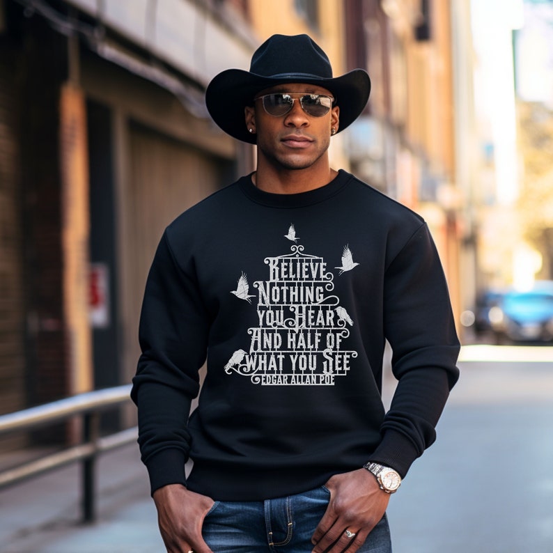 May include: A black sweatshirt with a white graphic print that reads 'Believe nothing you hear and half of what you see - Edgar Allan Poe'.