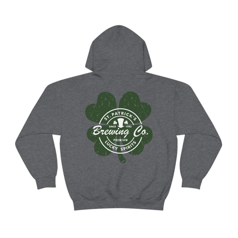 May include: A dark gray hoodie featuring a green shamrock design with the text "St. Patrick's Brewing Co. Premium Lucky Spirits" in white. The hoodie has a hood and long sleeves.