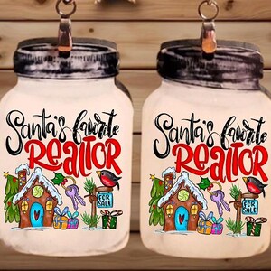 May include: A pair of Christmas-themed earrings shaped like mason jars. Each jar features the text "Santa's favorite Realtor" with a house, keys, and a bird illustration. The earrings hang from silver-colored hooks.