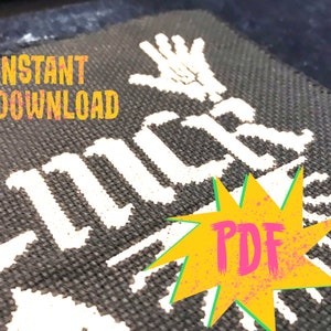 May include: A black and white cross stitch pattern with the text "INSTANT DOWNLOAD" and "LUCK" in white. A yellow starburst with the word "PDF" in pink is in the lower right corner.