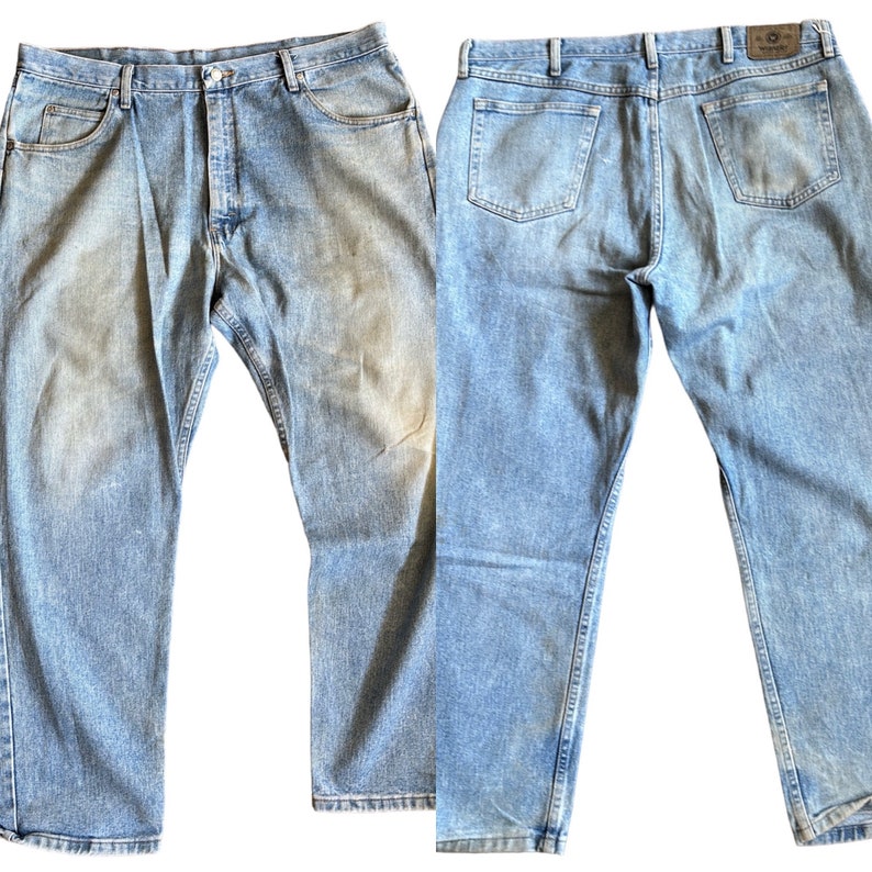 May include: A pair of light blue denim jeans with a straight leg fit. The jeans have a button fly and five pockets.
