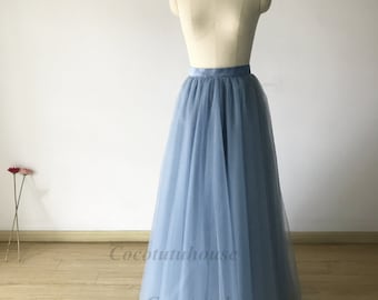 May include: A light blue tulle skirt with a satin waistband. The skirt is full and flowing, and it would be perfect for a special occasion.