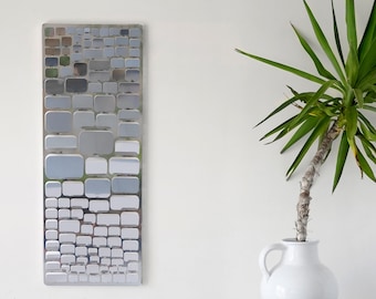 Stainless steel wall sculpture forming a model A mosaic